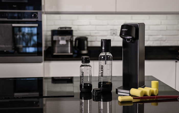 Kobieta w stroju sportowym trzyma butelkę z wodą po treningu na świeżym powietrzu